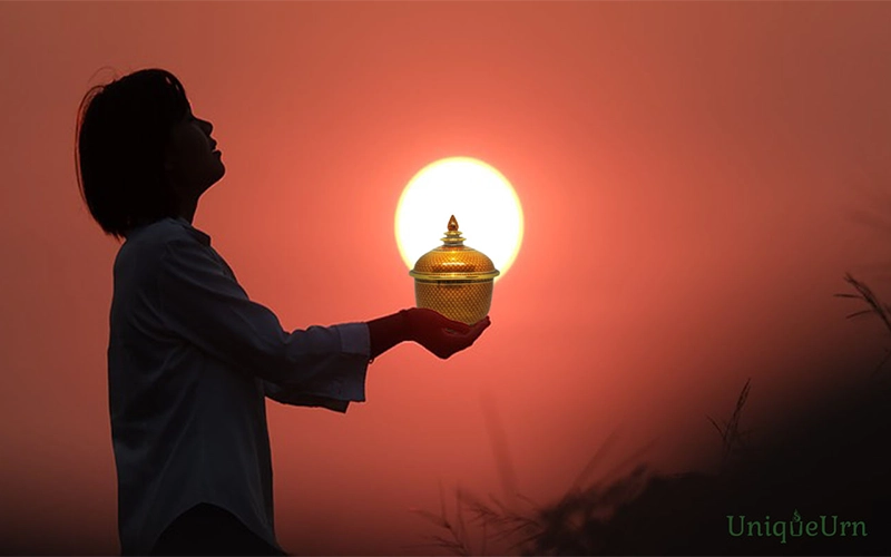 Image with an inspiration about life purpose and creating lasting value, encouraging meaningful living, and legacy building with UniqueUrn’s memorial art urns. Thochan urn 5 inch in KaoLarmTad Orange design