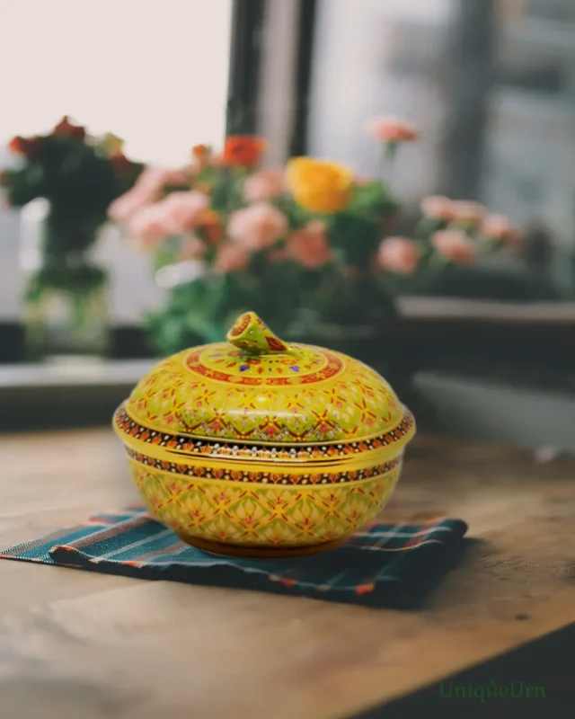 Honor loved ones with an exquisite handcrafted Bencharong oval Keepsake urn for ashes. Discover the profound art of remembrance with a funeral ceremony in Thailand.