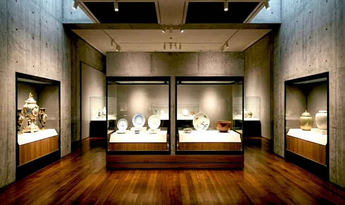 Comparison display of global porcelain identities: Sèvres precision, Wedgwood translucency, Imari asymmetry, and UniqueUrn tactile relief gold
