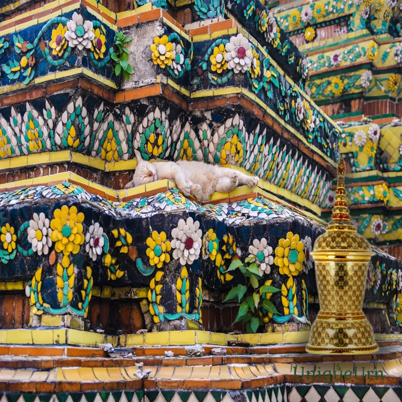 Meticulous porcelain floral ornamentation on the blue Great Stupas of Wat Pho represents a fusion of Thai and Chinese art styles, and the handcrafted ThoGrodChaTra Bencharong cremation Urn.