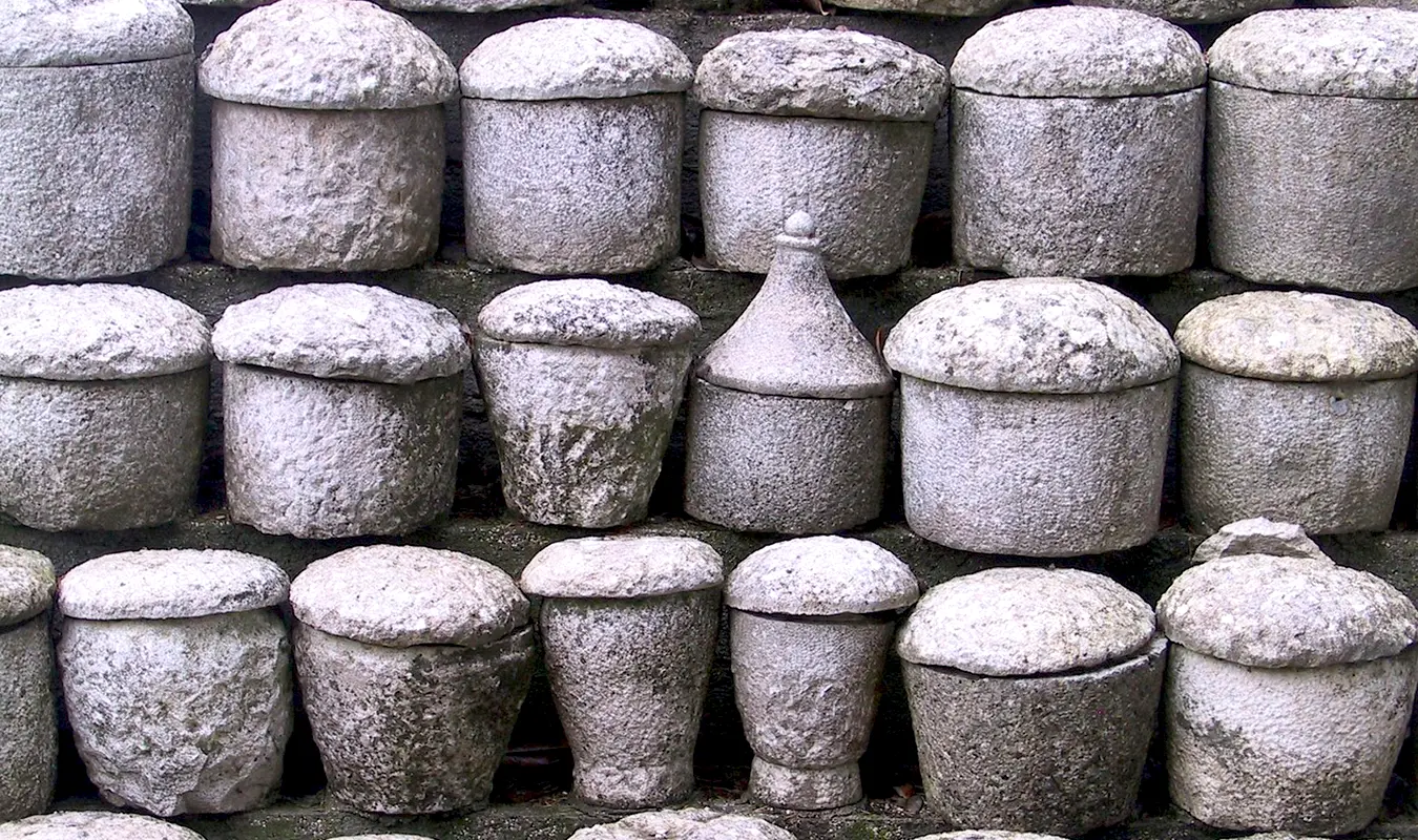 A curated selection of cremation urns for ashes in stone material.