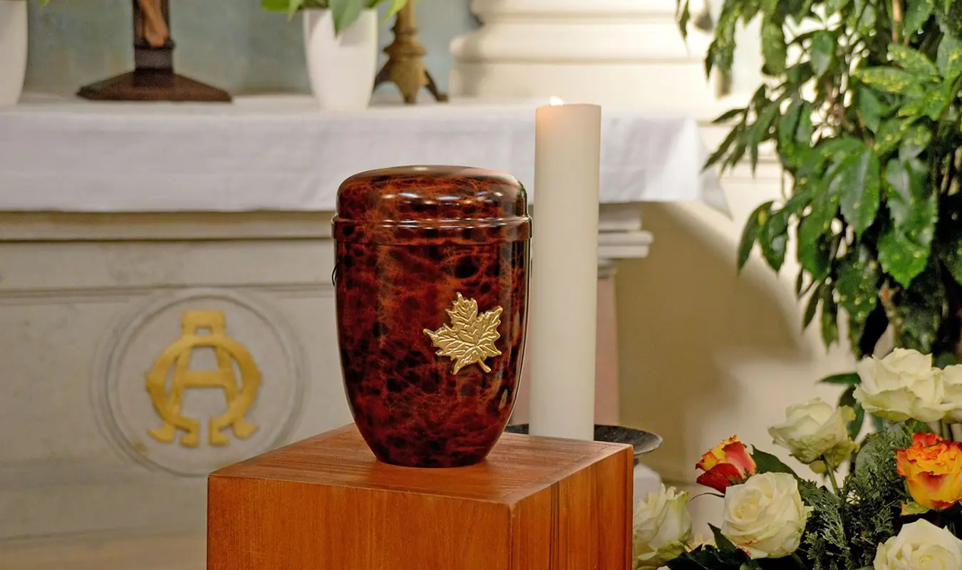 A curated selection of red memorial urns for ashes by metal material