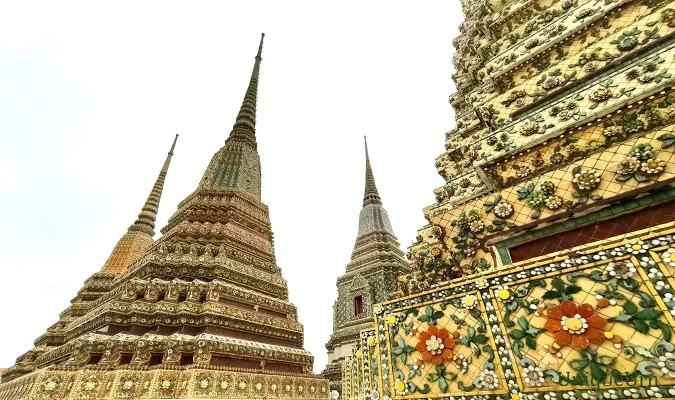 Meticulous porcelain floral ornamentation on the Great Stupas of Wat Pho represents a fusion of Thai and Chinese art styles - memorial arts as UniqueUrn.