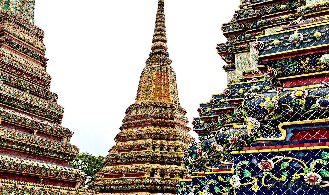 Meticulous porcelain floral ornamentation on the Great Stupas of Wat Pho represents a fusion of Thai and Chinese art styles - memorial arts as UniqueUrn.