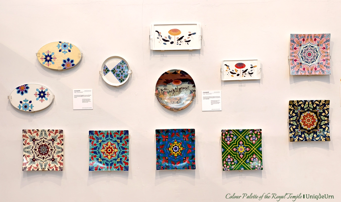 The colors and designs from 3 royal temples are painted on ceramic plates, which are displayed on the wall.