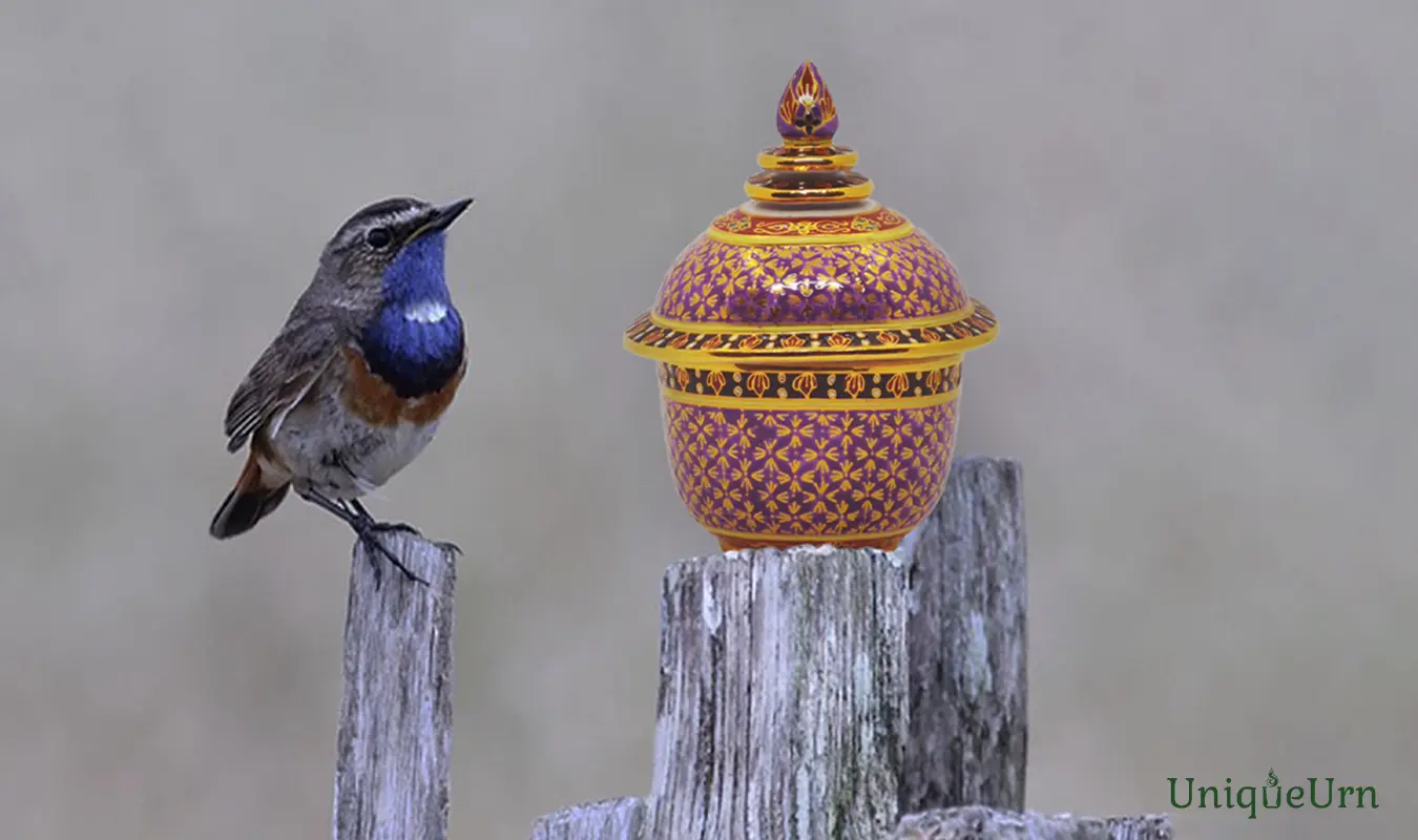 The Miracle of Being Awake: Transforming Loss into Peace, as the freedom bird and art of 18k gold hand-painted Thai Bencharong Thochan keepsake urn for ashes.