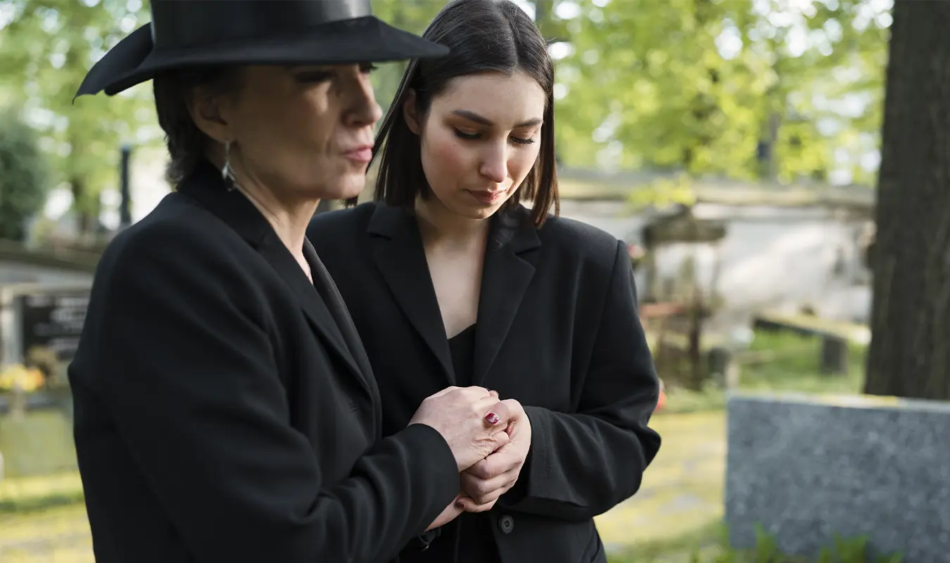 Relatives are holding hands and leaning on each other to encourage each other to get through the moment of losing a loved one together.